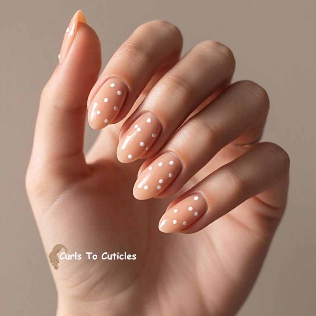 Peach Almond Nails design with white dots